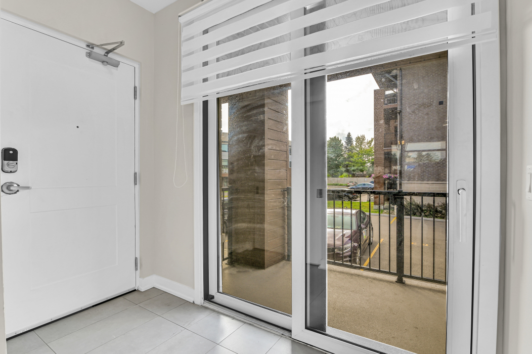 Glass balcony door providing access to outdoor space in a 2-bedroom Ottawa townhouse.