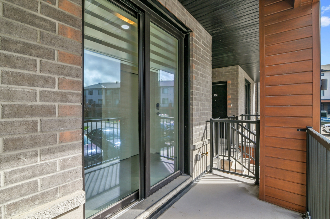 Double balcony doors opening to a private outdoor space in a Kanata townhouse.