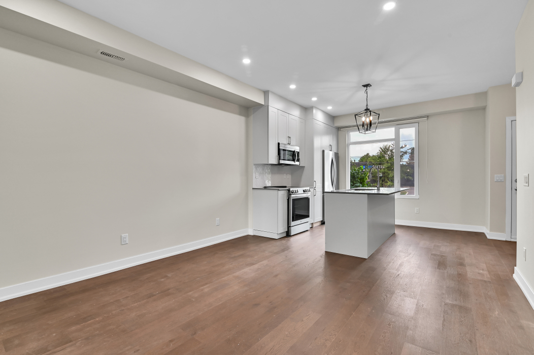 Spacious open-concept kitchen flowing into the living area of a 2-bedroom Kanata townhouse.