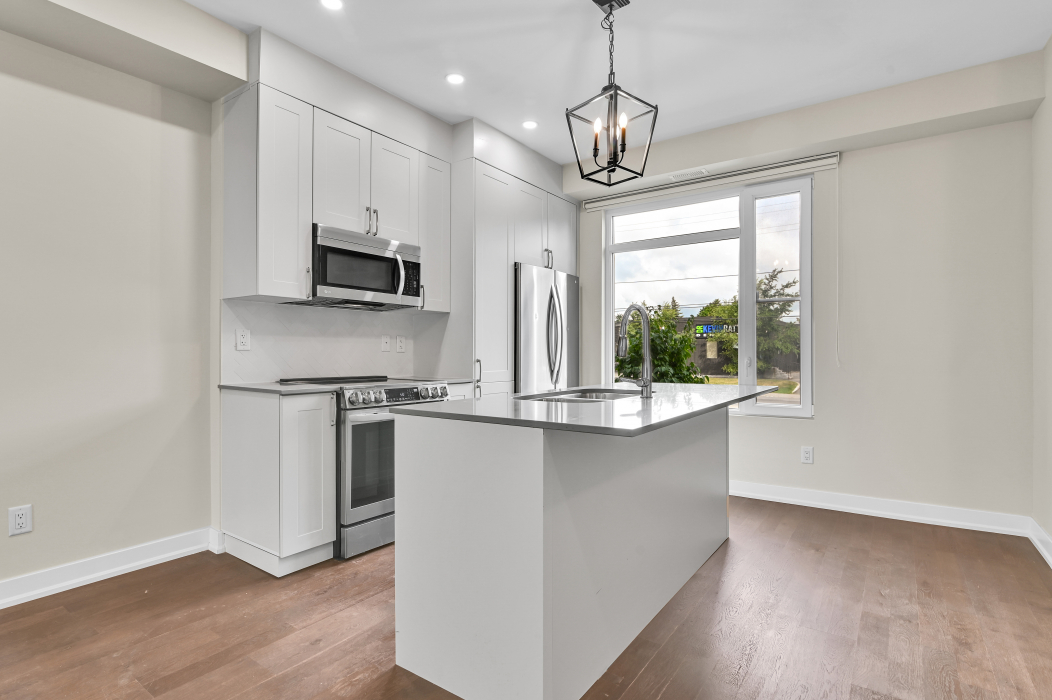 Large kitchen island with seating in a modern 2-bedroom townhouse in Ottawa.