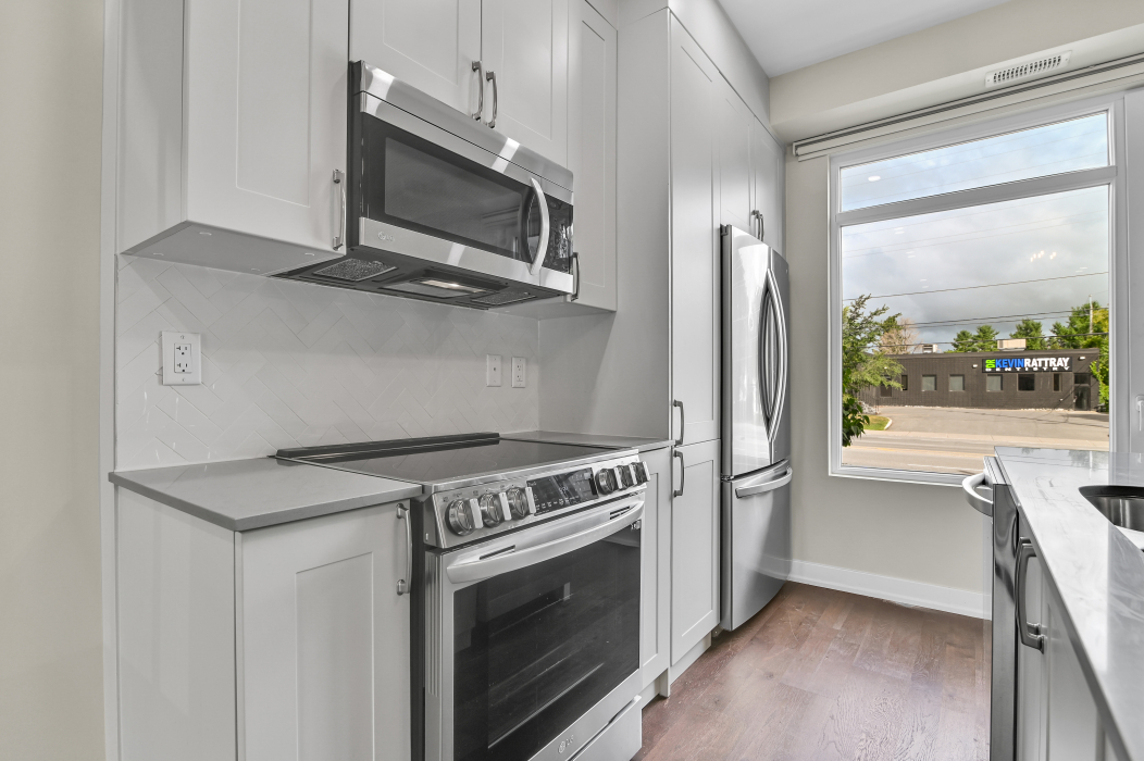 Sleek stove and microwave unit in the kitchen of a 2-bedroom Ottawa townhouse.