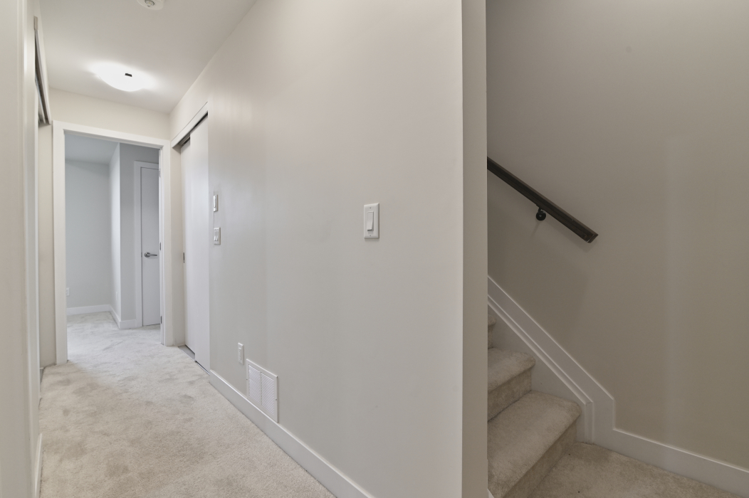 Basement steps providing access to additional living space in a 2-bedroom townhouse.