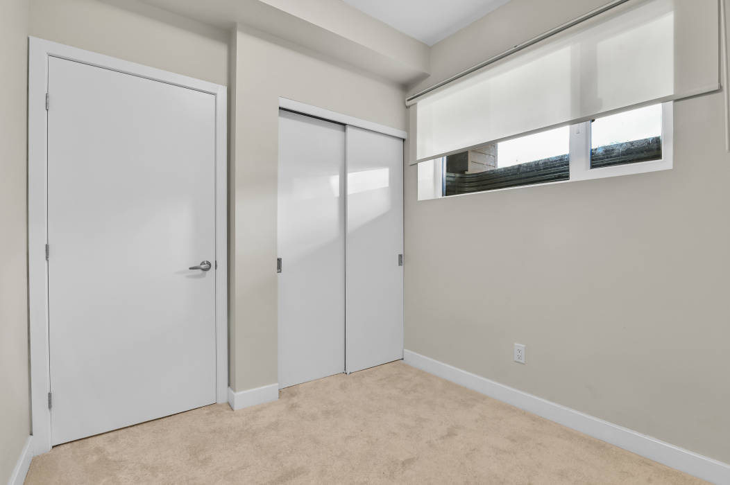 Comfortable bedroom featuring a large window in a 2-bedroom Ottawa townhouse.