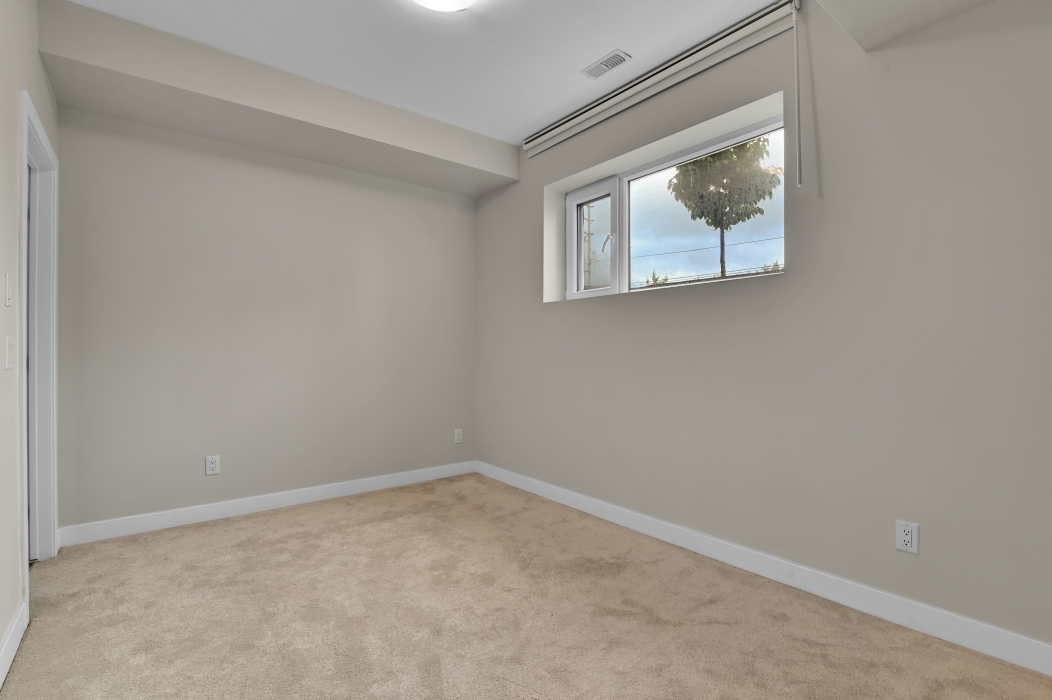Spacious master bedroom with ample natural light in a 2-bedroom townhouse.