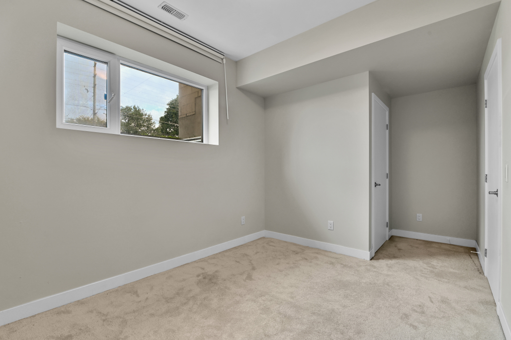 Large window providing sunlight in the master bedroom of a 2-bedroom Ottawa townhouse.