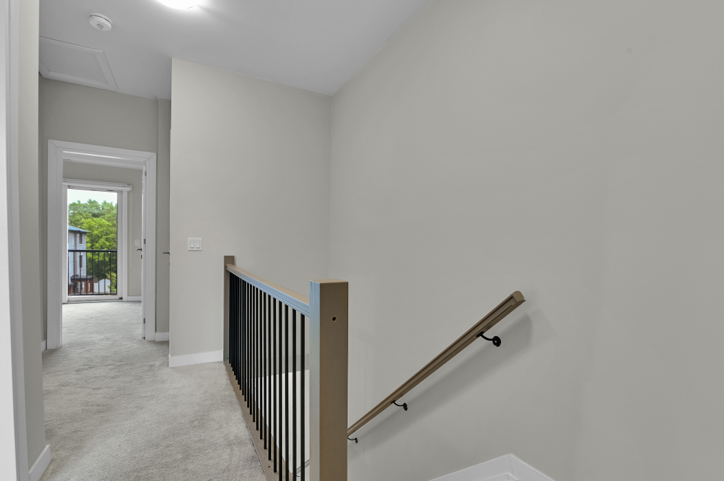 Railing along the stairs inside the 2-bedroom townhouse.