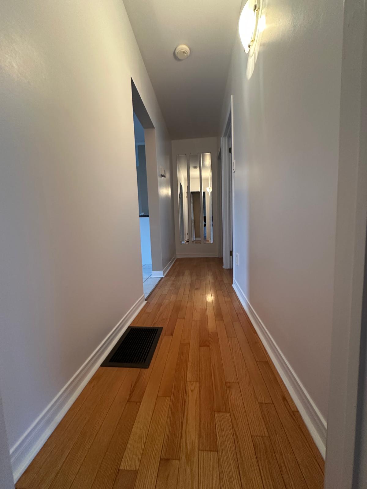 Clean and bright hallway leading to rooms in this 2-bedroom Ottawa rental.