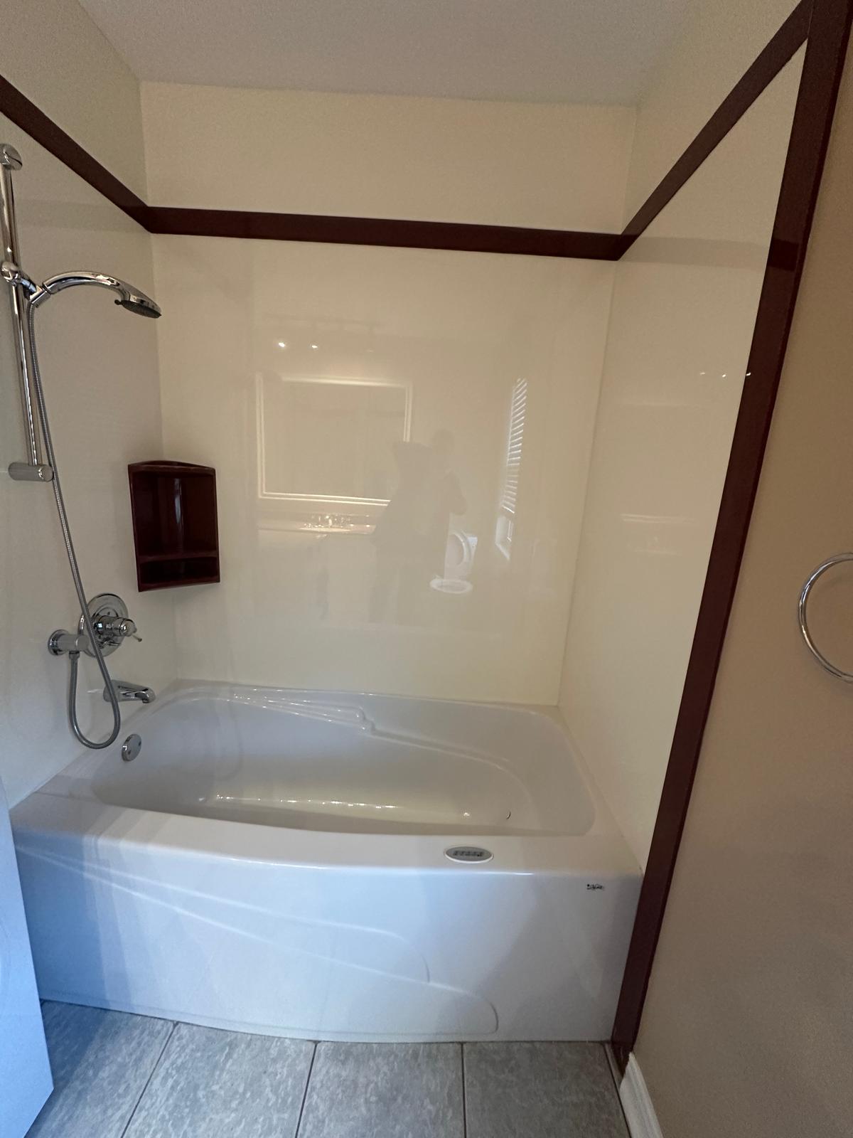 Clean shower stall within the 1-bathroom of a 2-bedroom apartment in Orleans.